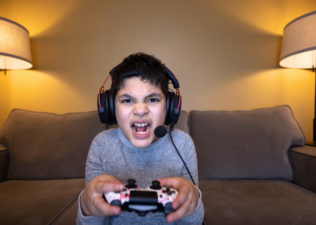 A kid making an angry face while playing a video game