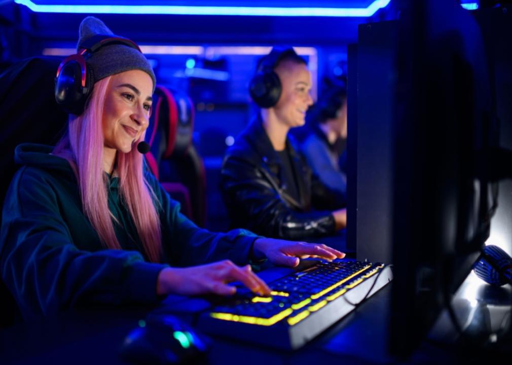 Two ladies playing video games and smiling