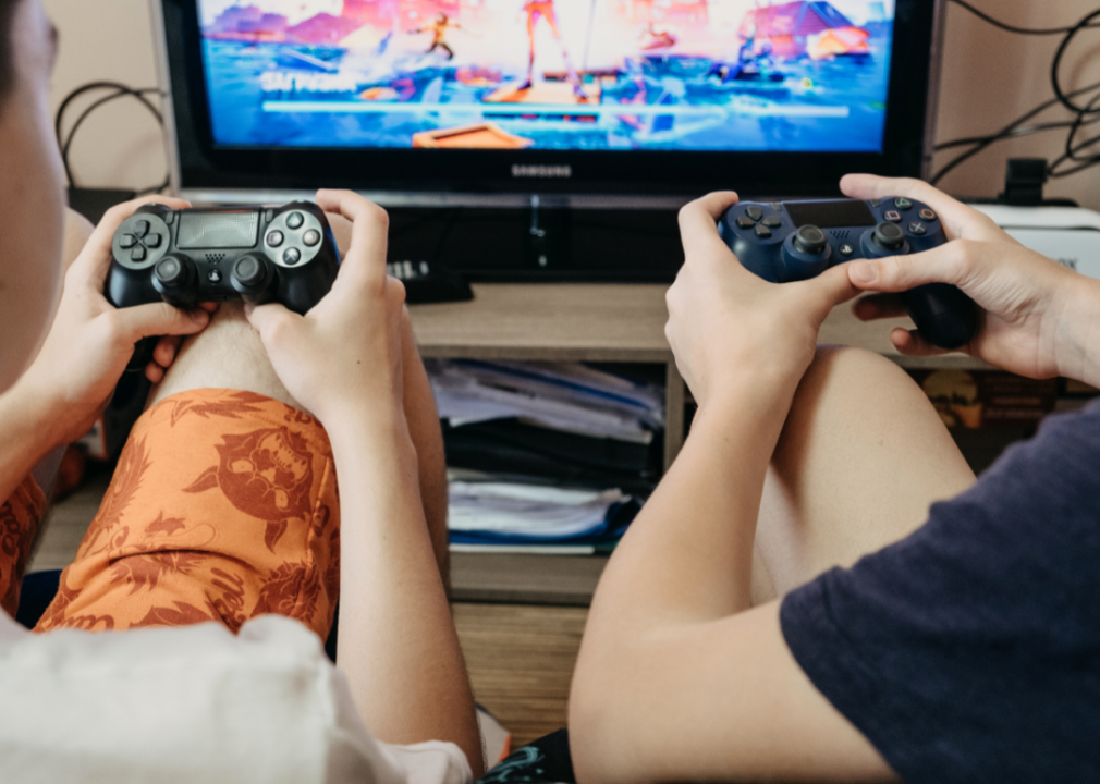Two people playing PlayStation